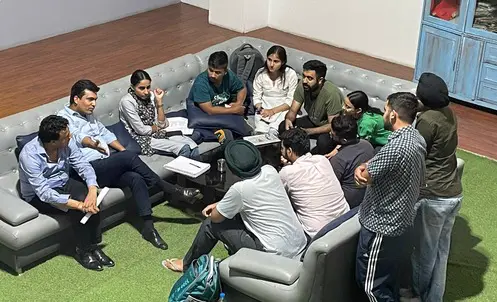 Chetan Sir in a discussion circle with students